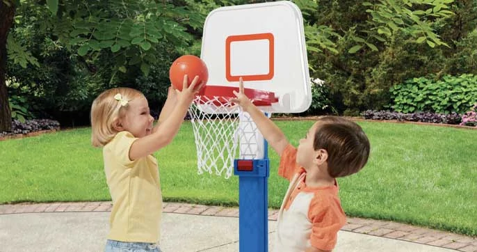 kid playing with basketball hoop
